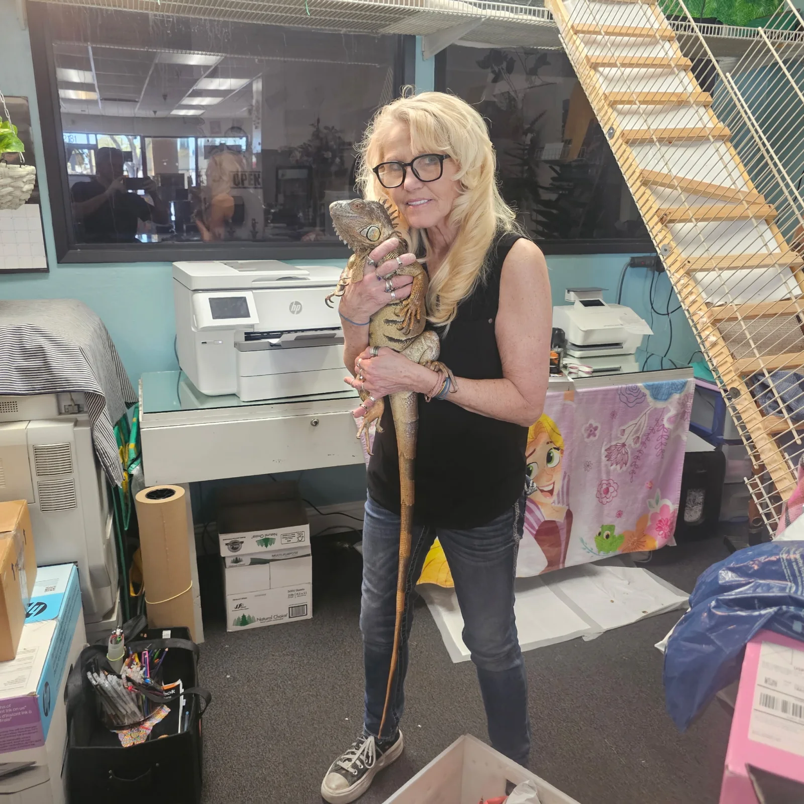Jolene Federico with Loki, her pet iguana and the Tracy Mail and More store mascot